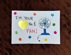 a piece of paper that says i'm your no 1 fan with a yellow heart on it