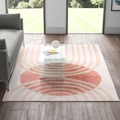 Mid-century modern inspiration. This indoor area rug features an abstract geometric pattern that fills your space with a retro vibe. A solid-toned circle along with curved concentric lines comes in orange and pink hues that are bound to stand out. Power-loomed from polypropylene, this rug's 0.28" pile height provides just the right amount of cushioning underfoot for kitchens, living rooms, and dining rooms. Even though it has a cotton backing, we recommend pairing it with a rug pad (sold separat Table Lamps Kitchen, Modern Inspiration, Abstract Area Rug, Cozy Dog Bed, Area Rug For Living Room, Nursery Furniture Sets, Abstract Geometric Pattern, Teen Bedding, Bedroom Furniture For Sale