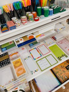 the desk is full of stationery and markers