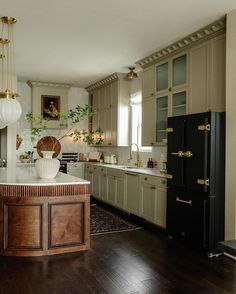 a large kitchen with wooden floors and cabinets