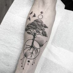 a black and white photo of a tree on the arm