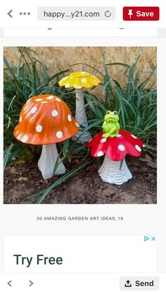 three small plastic mushrooms sitting on the ground next to some grass and flowers in front of a stone wall