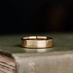 a gold ring sitting on top of an open book