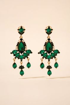 The earrings feature a teardrop-shaped rhinestone crystal at the top, with multiple smaller crystals hanging down in a chandelier style. The crystals are arranged in a beautiful pattern that creates a sparkling and elegant effect. The earrings are lightweight and comfortable to wear, making them perfect for special occasions. SizeLength: 2.75 in (6.99 cm)Width: 1.25 in (3.18 cm) QualityUses an eco-friendly, lightweight, strong metal alloy base structure. Adorned with dangling teardrop sparkling Crystal Drop Chandelier Earrings With Sparkling Stones, Glamorous Chandelier Drop Earrings With Sparkling Stones, Teardrop Crystal Chandelier Earrings, Teardrop Crystal Chandelier Earrings For Pierced Ears, Crystal Teardrop Pendant Earrings For Party, Party Crystal Teardrop Pendant Earrings, Party Teardrop Pendant Crystal Earrings, Jeweled Dangle Chandelier Earrings, Crystal Pear-shaped Chandelier Earrings For Parties