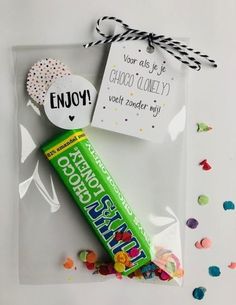 a candy bar and some confetti on a white surface