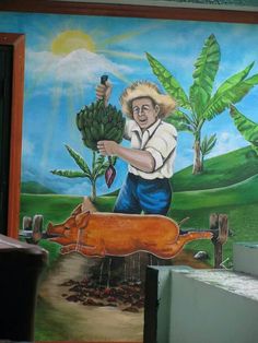 a mural on the side of a building depicts a man holding a plant and an animal