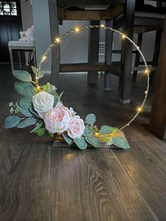 a wreath with flowers and lights on the floor