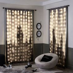 a living room filled with furniture and curtains covered in fairy lights next to a window