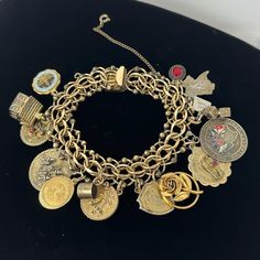 🌼 Double link 12 kt gold filled charm bracelet by Jacoby-Bender, with 13 charms.  Charms are as follows: State Capital of Texas, enamel, 10 kt House with hinged roof, unmarked Disneyland California, sterling I love you gold tone, unmarked I married an angel gold tone, unmarked thimble, unmarked 2 bells gold tone, unmarked 3d rose gold tone, unmarked our wedding day 12 kt gold filled six flags, Dallas, sterling Remember the Alamo, Sterling Texas Tech University, unmarked 🌼 Measures: 7 1/2" long Luxury Jubilee Charm Bracelet, Vintage Gold Charm Bracelet With Dangling Charms, Vintage Gold Bracelet With Charms, Heirloom Gold Bracelets With Vintage Charm, Vintage Gold Charm Bracelet Collectible, Gold Bracelet With Vintage Charm, Gold Charm Bracelet With Dangling Charms In 14k Gold, Gold Bracelets With Vintage Charm, 14k Gold Charm Bracelet With Dangling Charms