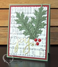 a close up of a card with holly and berries on it, along with the words joy