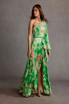 Be on the best-dressed list at your next event wearing our Caprice Maxi Dress. This vibrant style designed from printed charmeuse features a one shoulder design complimented by a voluminous long sleeve, self-tie waist band and a floor-length gathered skirt. European Wedding Guest Dress, Garden Cocktail Attire Wedding, Bohemian Dress Code, Garden Party Dress Code, Hippie Chic Weddings, Bohemian Dress Formal, Garden Wedding Dress Guest, Atelier Dress, Black Tie Wedding Guest Dress