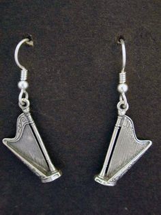 silver earrings with an arrow design on them