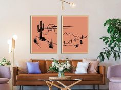 two paintings on the wall above a couch in a living room