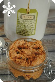 a glass jar filled with food sitting on top of a wooden table