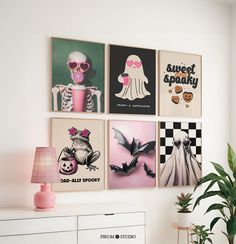 a living room with pictures on the wall and a potted plant next to it