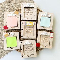 wooden frames with magnets attached to them sitting on a woven basket next to a piece of paper