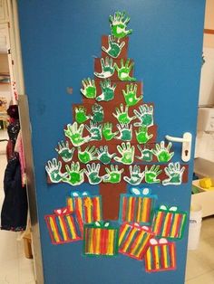 a door decorated with handprints on the front and side of a christmas tree