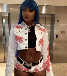 a woman with blue hair wearing a white jacket and black top is standing in front of an elevator