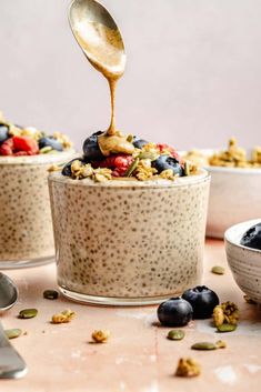 an oatmeal bowl with blueberries, raspberries and granola