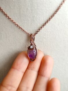 This is a cute and tiny pendant with a natural amethyst stone with a small shell bead. It is small and cute, a great addition to any style of outfit. The metal part is solid copper that has been oxidized for an antique look. • Pendant size : H 3 x W 1.2 cm 🎁 This pendant comes with a free 18" copper chain necklace. Ready to wear or give as a gift. ✨ One-of-a-kind item ✨ There is only one of these. You will get the exact pendant as seen in the photos. CARE INSTRUCTION • Wire-wrapped jewellery is Necklace With Small Stone, Small Wire Wrapped Stone, Oval Wire Wrapped Pendant, Wire Wrap Small Stones, Small Wire Wrapped Pendant, Elegant Wire Wrapped Jewelry, Simple Wire Wrapped Pendant, Wirewrap Jewelry, Wire Wrapped Jewellery