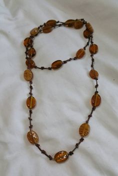 Metal Free, Boho Style 38 inch Necklace, Brown and Gold Lucite Oval Beads with Brown Knotted Cord., Costume Jewelry, Fashion Accessory This is a nice find and priced to sell.  There are no flaws on this necklace.   Check out our shop for monthly specials. We have a variety of items for every taste. Combine several of our items together to save on shipping. If you have any questions please do not hesitate to ask. I will ship outside of the US, just request a quote. Happy Shopping. I will work around the priority mail price. Just send me your zip code and I will get a quote. As shop owners we will do our best to describe any issues or problems with our items. Since we do sell vintage and antiques there may be some flaws. Please check out the pictures very carefully and feel free to ask any q Adjustable Amber Oval Beads Jewelry, Adjustable Amber Jewelry With Oval Beads, Bohemian Oval Beaded Necklaces, Bohemian Oval Beaded Necklace, Adjustable Brown Beaded Necklaces With Oval Beads, Adjustable Brown Oval Beads, Adjustable Oval Beads Necklace For Beach, Adjustable Brown Long Necklace With Large Beads, Adjustable Oval Beaded Necklace