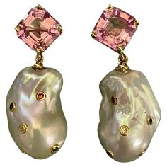 Morganite is paired with baroque pearl in these elegant dangle earrings. Morganite is part of a large family of gemstones which include aquamarine, heliodor, golden beryl, emerald and chrysoberyl. These gems (origin: Brazil) are a delicate pink, are perfectly matched, cut and polished. The pearls (origin: China) are bright white, baroque in surface and possess beautiful luster. They are studded with bezel set multi-colored sapphires and diamonds. The hand made yellow gold settings come with post Colored Sapphires, Golden Beryl, Yellow Gold Setting, Large Family, Color Rosa, Baroque Pearls, Morganite, Bezel Setting, Bright White