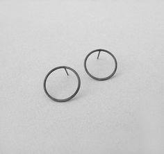 Open circle silver earrings, Oxidized black round circle post earrings, geometric jewelry, everyday earrings, gifts under 20 This pair of open circle post earrings are easy to wear everyday and can match any outfit. A geometric and minimalist design you will love everyday! These are hand formed from sterling silver wire and oxidized with patina. You can choose the diameter of the circle is either 15 mm (0.6''), 20 mm (0,8'') or 43 mm (1,7'') . You can also choose to have them either black oxidiz Black Circle, Earrings Geometric, Round Circle, Geometric Jewelry, Everyday Earrings, The Circle, Silver Wire, Post Earrings, Circles