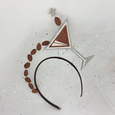 a brown and white headband with star decorations on the top, along with other accessories