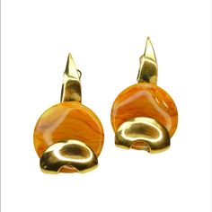 pair of gold toned earrings with an orange and yellow swirl design on each earring