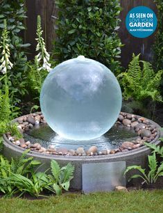 a water feature in the middle of a garden