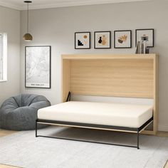 a bed with a wooden headboard and foot board next to a gray bean bag chair