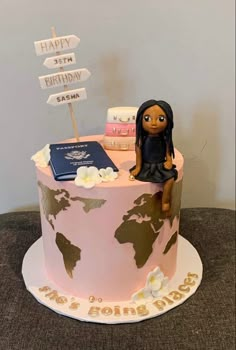 a birthday cake with a woman sitting on top of it