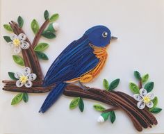 a blue bird sitting on top of a tree branch with white and yellow flowers around it