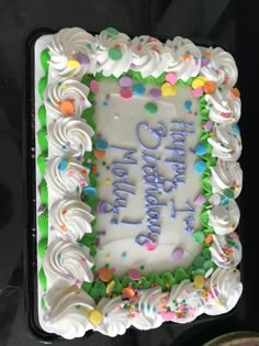 a birthday cake with white frosting and sprinkles