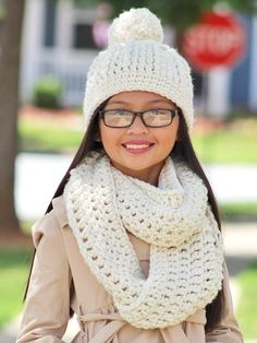 a woman wearing a white knitted hat and scarf