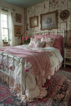 a bedroom with floral wallpaper and pink bed linens on the bedspread