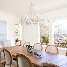 a dining room table with chairs and a chandelier