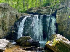 there is a waterfall in the middle of some rocks