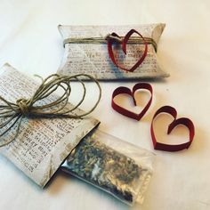 two bags filled with dried herbs sitting on top of a table