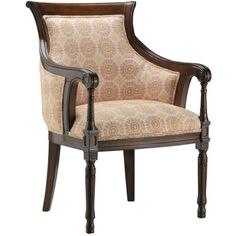 the arm chair is upholstered with an intricate pattern and wood trimmings