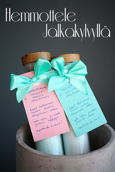 two jars with notes attached to them sitting on a table next to each other in a vase