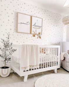 a baby's room with polka dot wallpaper and white crib