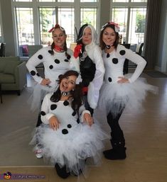 four women dressed in costumes posing for a photo