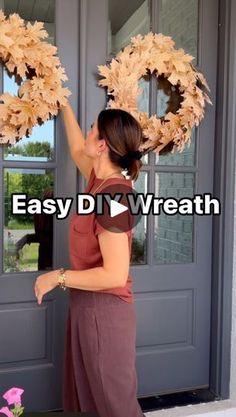 a woman is holding two wreaths in front of a door with the words easy diy wreath on it