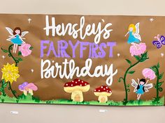 a sign that says, hey's fairy first birthday with pictures of mushrooms and flowers