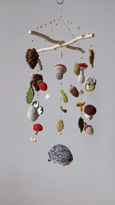 a mobile made out of knitted objects hanging from a ceiling