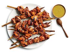 chicken skewers and dipping sauce on a plate