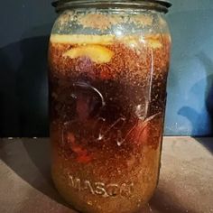 a jar filled with liquid sitting on top of a table