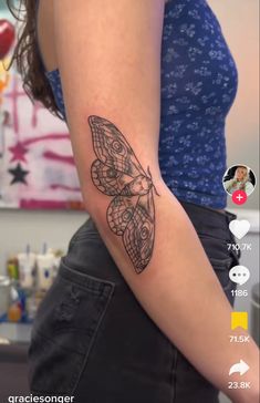 a woman's arm with a butterfly tattoo on the left side of her arm