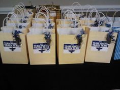 several brown paper bags with blue bows on them